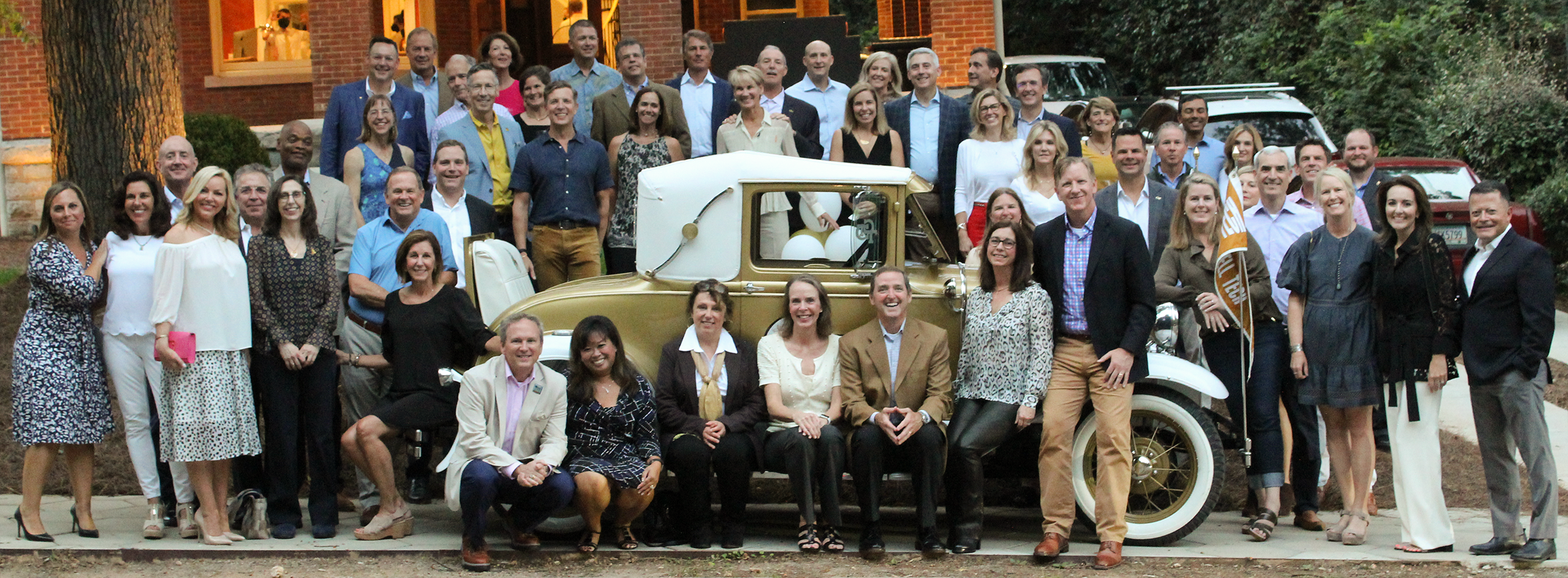 A group of more than 50 people in front of GT Ramblin' Wreck.